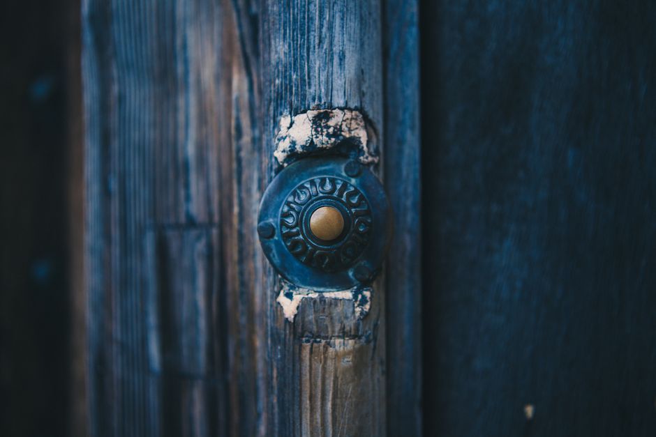 Battery video doorbell mounted beside a front door