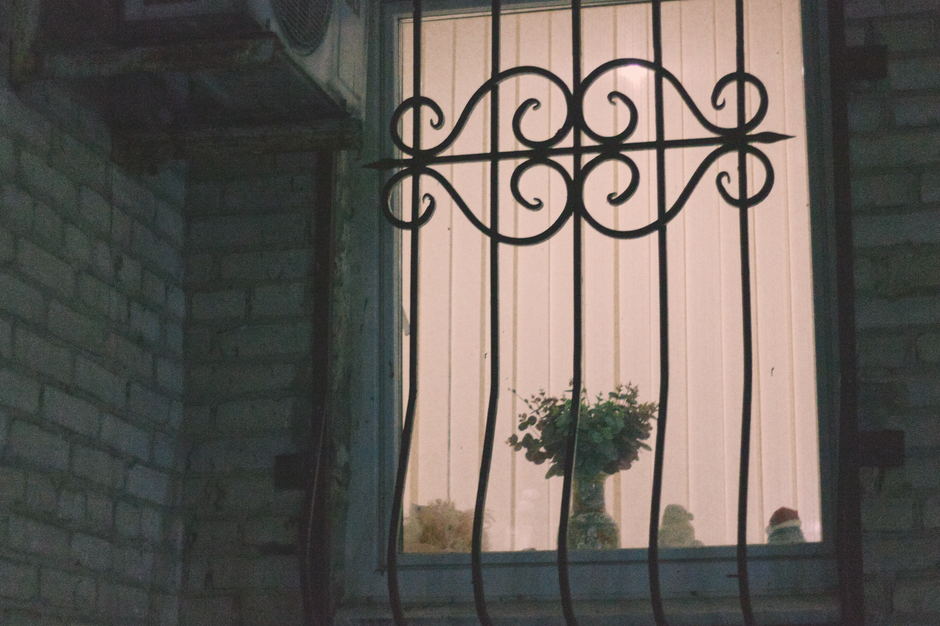 Small indoor outdoor security camera on a window sill