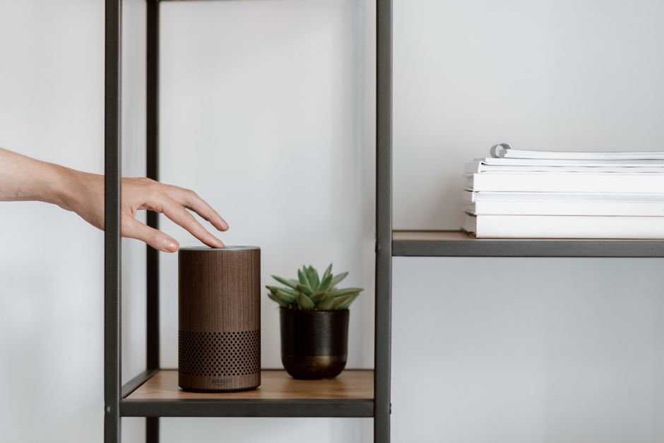 Smart speaker and plug-in devices on a shelf in a rented flat